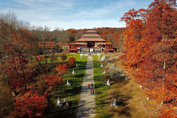 Experience the tranquility of Chuang Yen Monastery surrounded by stunning fall foliage followed by an enjoyable three-hour shopping spree at Woodbury Common Premium Outlets. A journey of serenity and fun awaits!